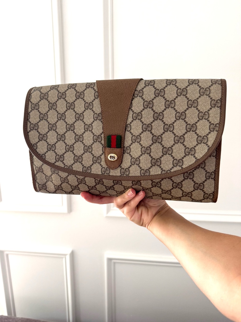 Authentic Gucci brown monogram supreme coated canvas clutch bag
